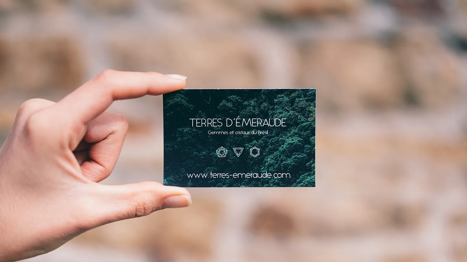 A hand holding up a business card, the one link that always shows your current details